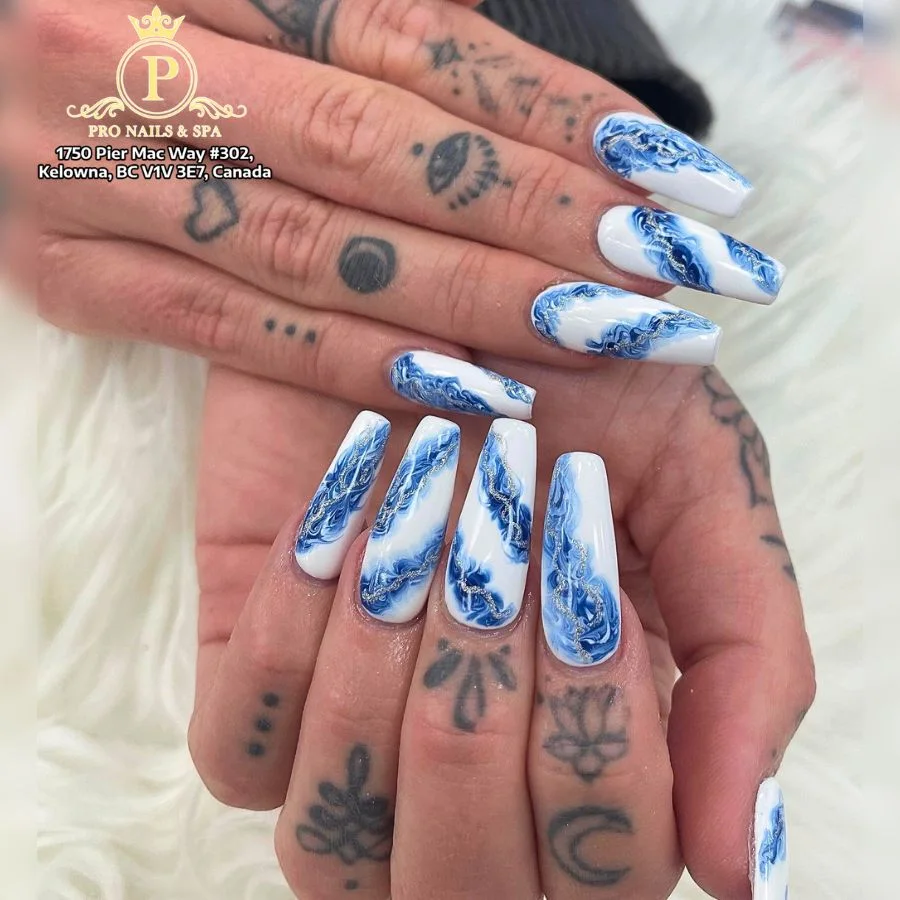 Blue marble and white floral nail art